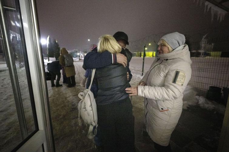 Yana Maylk hugs her father, Volodymyr, and mother, Natalia, as she enters Ukraine from the Polish border last month. Commercial flights into Ukraine have been suspended because of the war with Russia. Maylk took a train from Katowice, Poland, to the border town of Prezmys’l before taking a shuttle bus to the crossing.