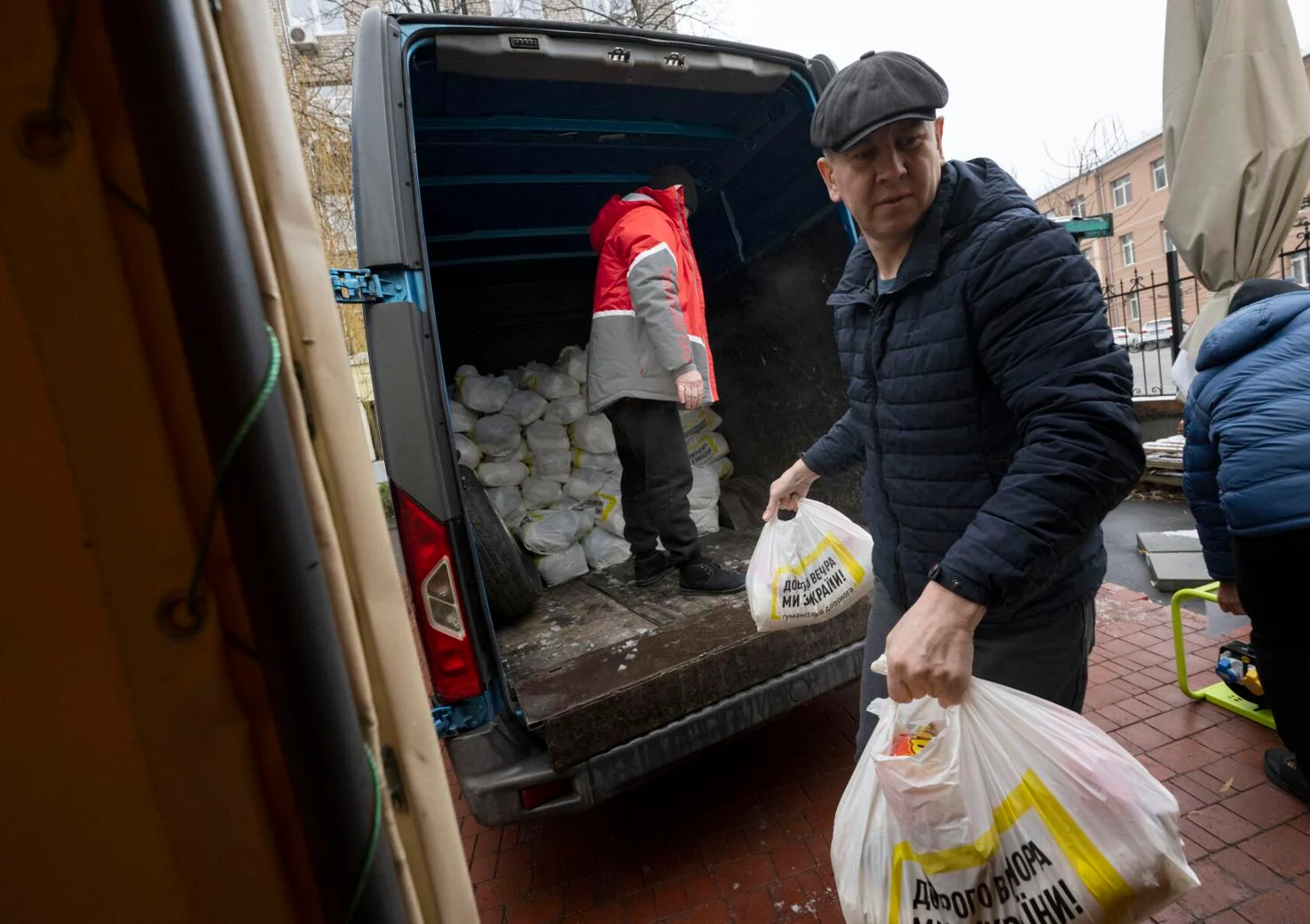 Workers unload a van full of food and personnel needs for refugees at a government hub last month in Dnipro, Ukraine. Twenty-five hubs are set up around Ukraine to help the refugees displaced from the war with Russia. Photo by Christian Murdock, The Gazette.