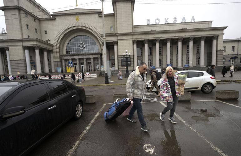 Kolomijtsev Oleksandr, the head of the Department for Reconstruction and Development of Infrastructure in Dnepropetrovsk, helps Yana Malyk with her bags last month at the train station after she arrived in Dnipro, Ukraine, from Truskavets. Photo by Christian Murdock, The Gazette