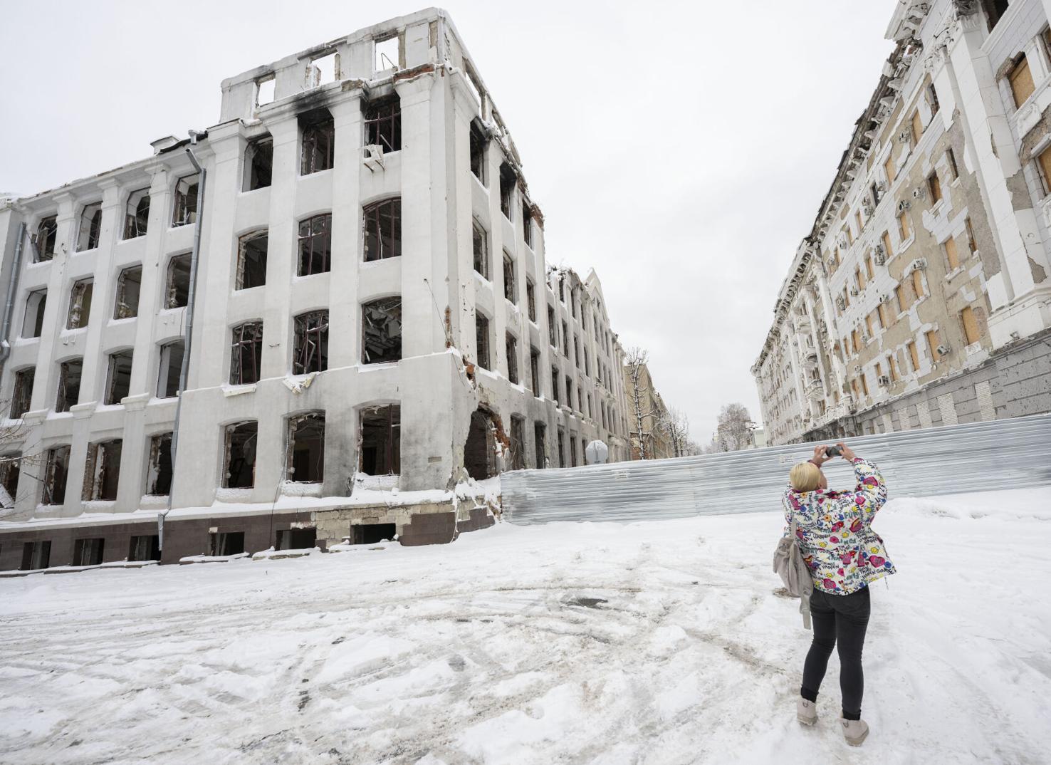 Yana Malyk takes a picture of at bombed buildings at the university in downtown Kharkiv, Ukraine, Dec. 13, 2023. Photo by Christian Murdock, The Gazette.