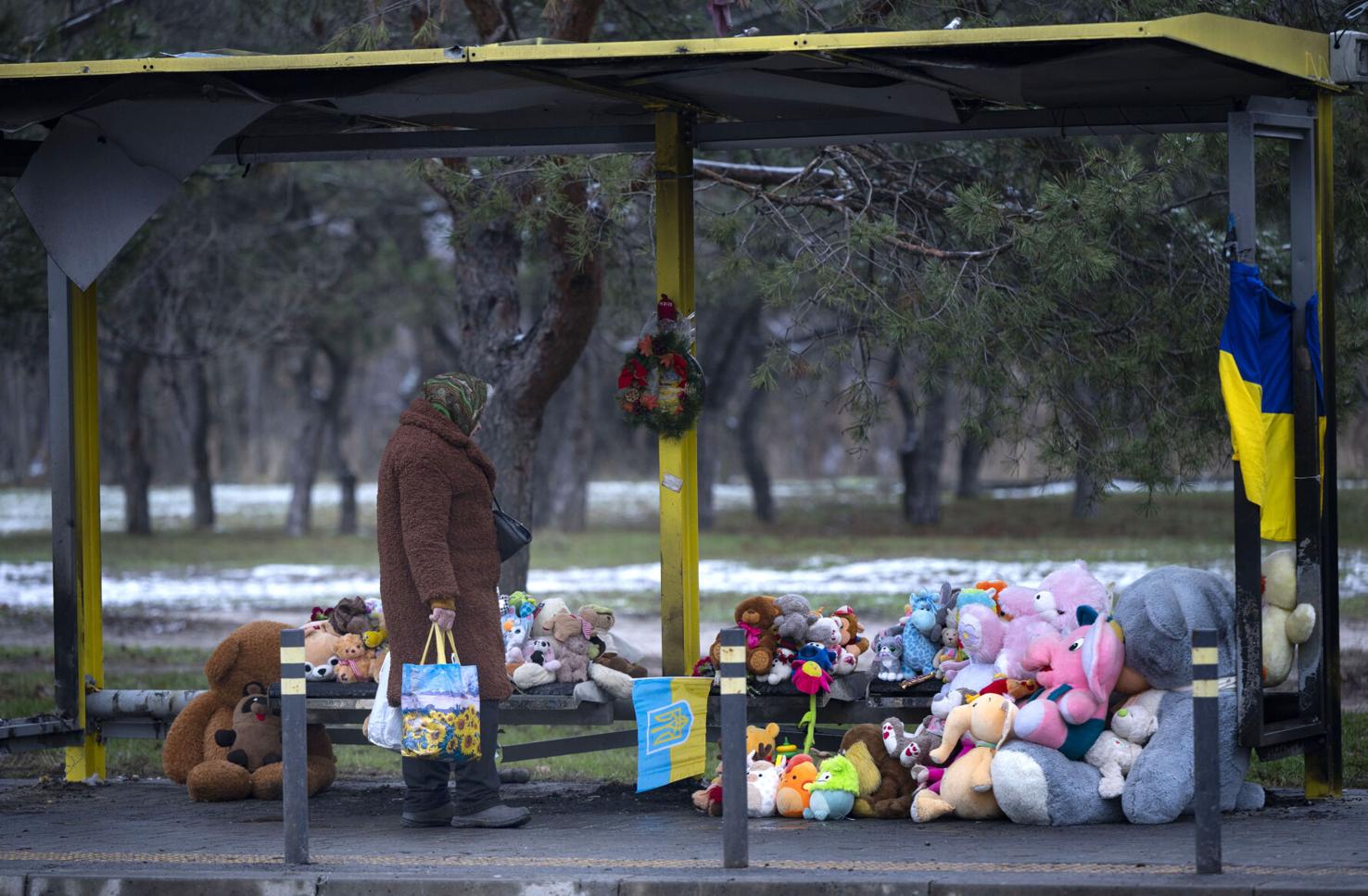 A woman walks by a memorial Monday Dec. 11, 2023, for the 46 killed, including six children, and the 80 injured in an attack by the Russians Jan 14, 2023, in Dnipro, Ukraine. Eight people are still missing. Some the dead were refugees from the Luhansk Region of Ukraine where Malyk lived. (The Gazette, Christian Murdock)