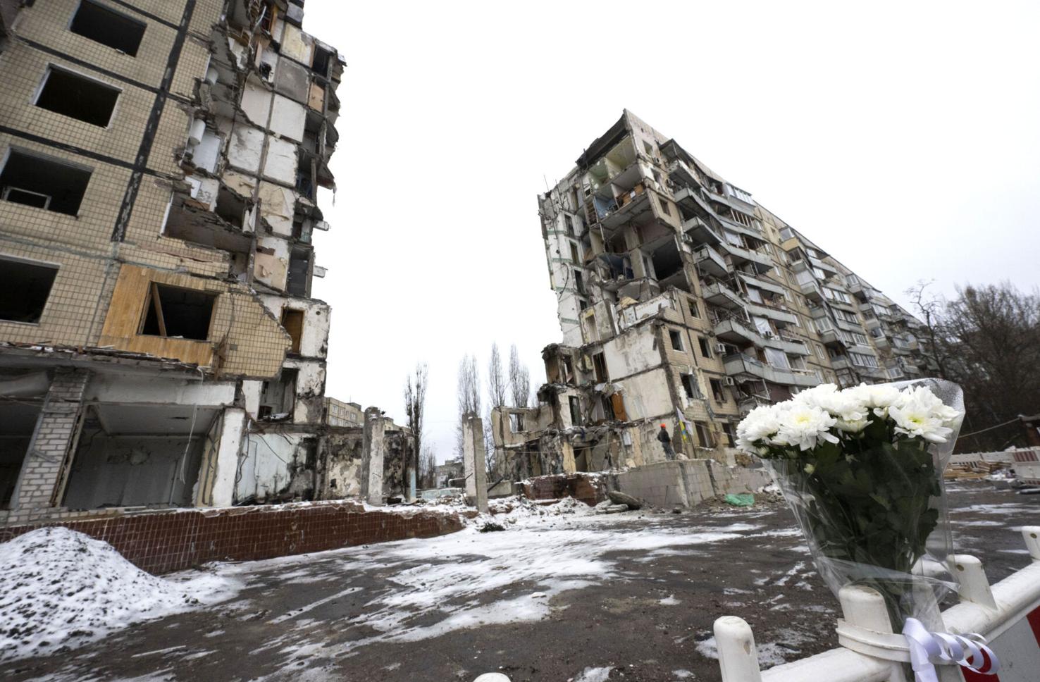 Fresh flowers are tied to a barracade surrounding an apartment building in Dnipro, Ukraine, Monday, Dec. 11, 2023, that was attacked by the Russians on Jan. 14, 2023. The attack killed 46, including six children, and injured 80 people. Eight are still missing. Some the dead were refugees from the Luhansk Region of Ukraine where Malyk lived. (The Gazette, Christian Murdock)